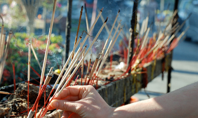 Lighting incense at a temple in Chiang Mai